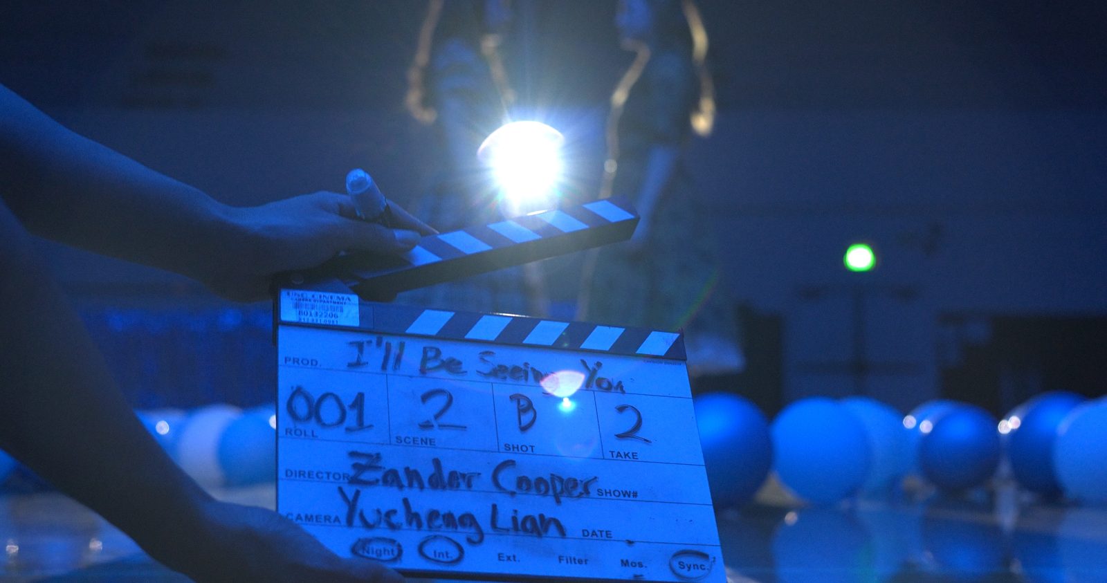 The slate for I’ll Be Seeing You, lit blue under a single light on the dance set