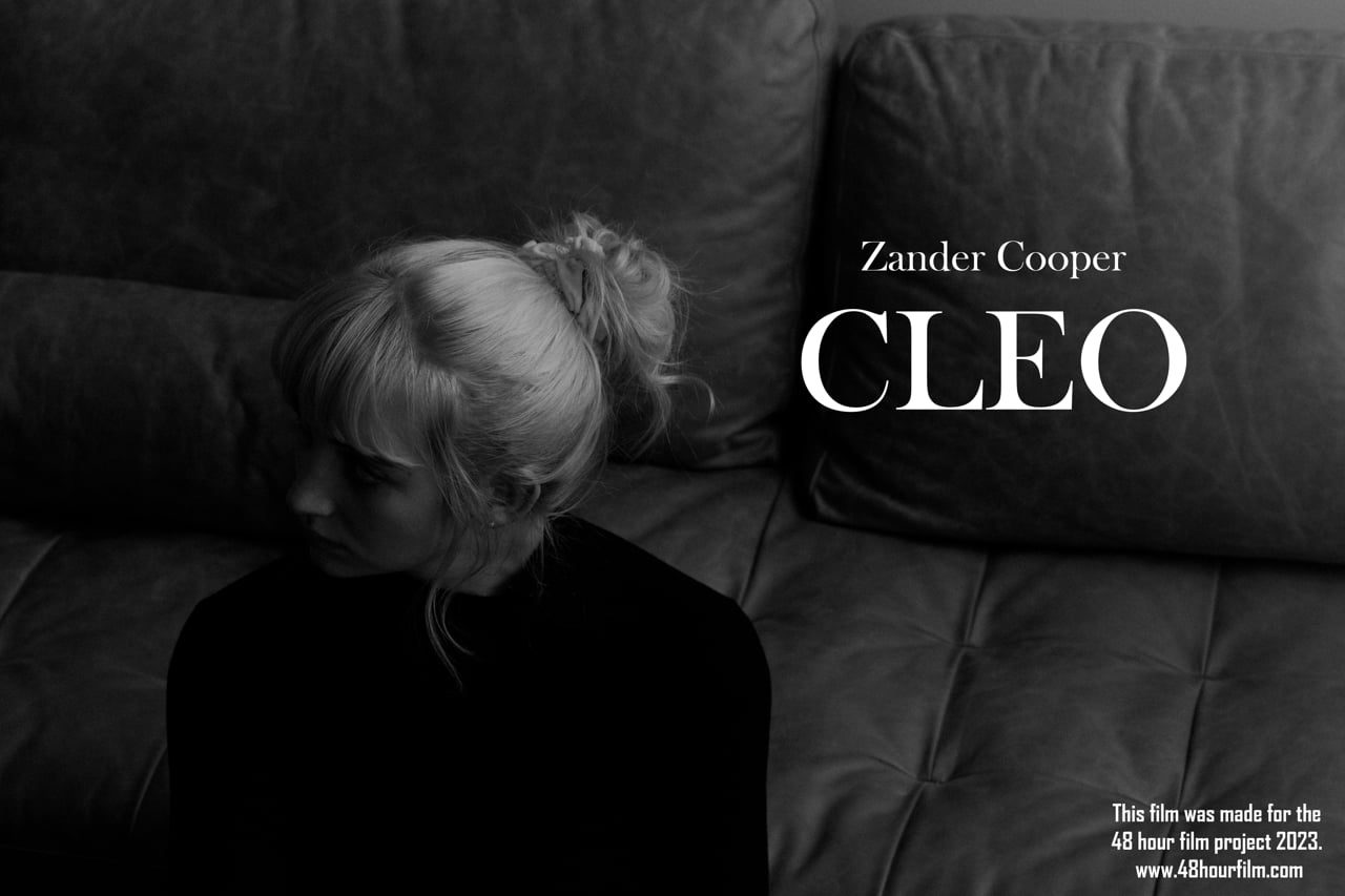 Black-and-white still of a woman on a sofa